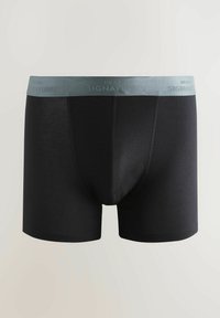 Schwarze Boxershorts mit einem weichen, elastischen grauen Bund, der mit "NEXT SIGNATURE" Text versehen ist. Glattes Material mit einer engen Passform.