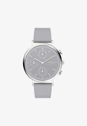Silberne Uhr mit einem grauen Silikonarmband. Rundes Gehäuse, graues Zifferblatt mit Stunden-/Minutenmarkierungen, Unterzifferblättern und Datumsanzeige. Einfaches Design.