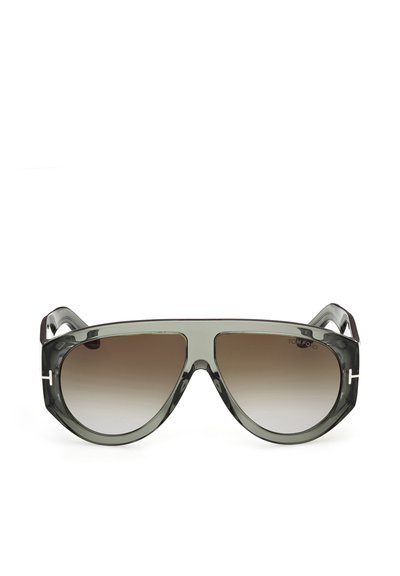 Lunettes de soleil avec une monture grise translucide surdimensionnée, des verres marron dégradés et de petits détails argentés en forme de "T" sur les branches.