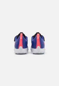 Athletic shoes with a blue upper, pink accents, and black heel tab. White rubber outsole with textured traction pattern.