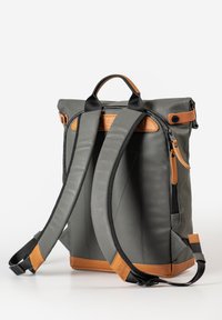 Gray roll-top backpack with brown leather accents, padded straps, zip closures, and a structured shape, suitable for everyday use.