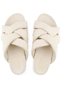 Beige slide sandals with braided straps, made from soft material. Flat soles with a smooth texture and rounded toe shape.
