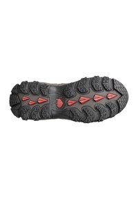 Black rubber shoe sole with deep treads and red triangular accents; designed for traction and durability in outdoor conditions.