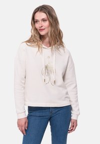 Helle beige Kapuzenpullover mit einem Frontgrafik, die ein goldfarbenes Umrissdesign zeigt. Weicher Stoff, lockere Passform, mit verstellbaren Kordeln und gerippten Bündchen.