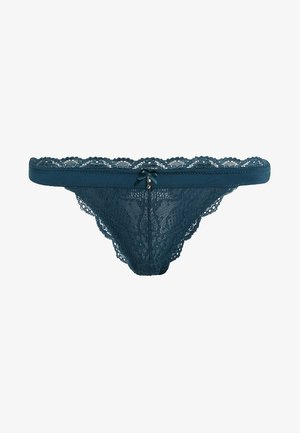 Teal lace thong with scalloped edges, featuring a central bow and small charm detail. Soft texture and intricate floral lace pattern.