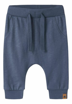 Soft blue toddler pants with elastic waistband, front pockets, drawstring, cuffed ankles, and a small brown tag on the left cuff.