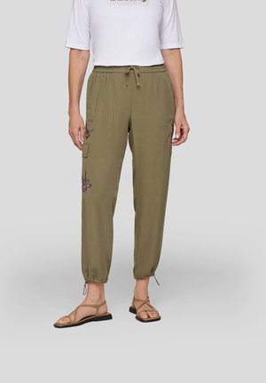 Olive green cargo pants with drawstring waist, gathered cuffs, and floral embroidery detailing on the left leg. Worn with tan sandals.