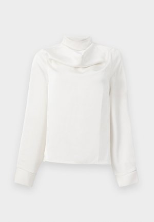 Valge pika varrukaga blousee kõrge kaelusega, valmistatud siledast kangast; omab mansettidega varukaid ja sirget alläära.