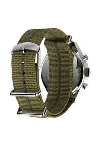 Montre Timex avec un bracelet en tissu vert, boucle en acier inoxydable et quincaillerie en acier argenté. Elle présente un boîtier rond et une surface de bracelet texturée.