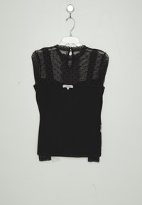 Schwarzes Oberteil mit einem transparenten, gepunkteten Paneeldesign an den Schultern, Spitzenakzenten und einer Schlüssellochöffnung am Rücken. Glattes Material.