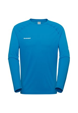 Blå atletisk langærmet top med rund hals, "MAMMUT"-logo på venstre bryst og diskrete syningsdetaljer på ærmer og skuldre.