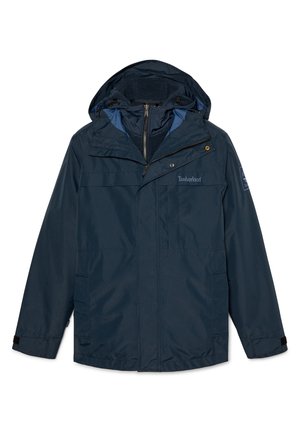 Marineblaue wasserfeste Jacke mit einer gefütterten Kapuze aus Fleece, Reißverschluss vorne und mehreren Taschen. Verfügt über verstellbare Bündchen und ein Timberland-Logo.