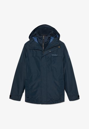 Chaqueta impermeable de color azul marino con capucha forrada de forro polar, cierre zip frontal y múltiples bolsillos. Incluye puños ajustables y detalles del logo de Timberland.