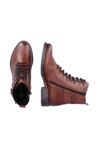 Bottes à cheville en cuir marron avec un bout arrondi, un laçage à l'avant, une fermeture éclair sur le côté et un panneau texturé sur le talon. Semelle en caoutchouc robuste.