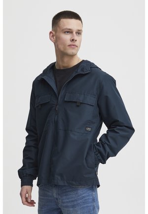 Navy blue, hooded windbreaker jacket with two front pockets and elastic cuffs, made of textured fabric with a subtle striped pattern.