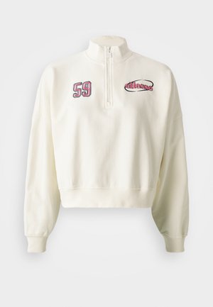 Sudadera corta color crema con cierre de media cremallera en el frente, con números bordados "59" y el logo de la marca en rosa y negro. Textura suave.