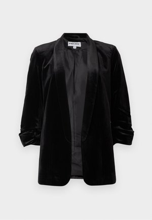 Black velvet blazer with a shawl collar, rolled sleeves, and an open front. Smooth texture with a satiny sheen. No fastenings.