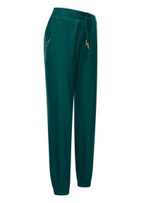 Turkosa, lätta byxor med elastiska mudd och midja. Har dragsko och dekorativa metallaccenter på fickorna. Slät textur.