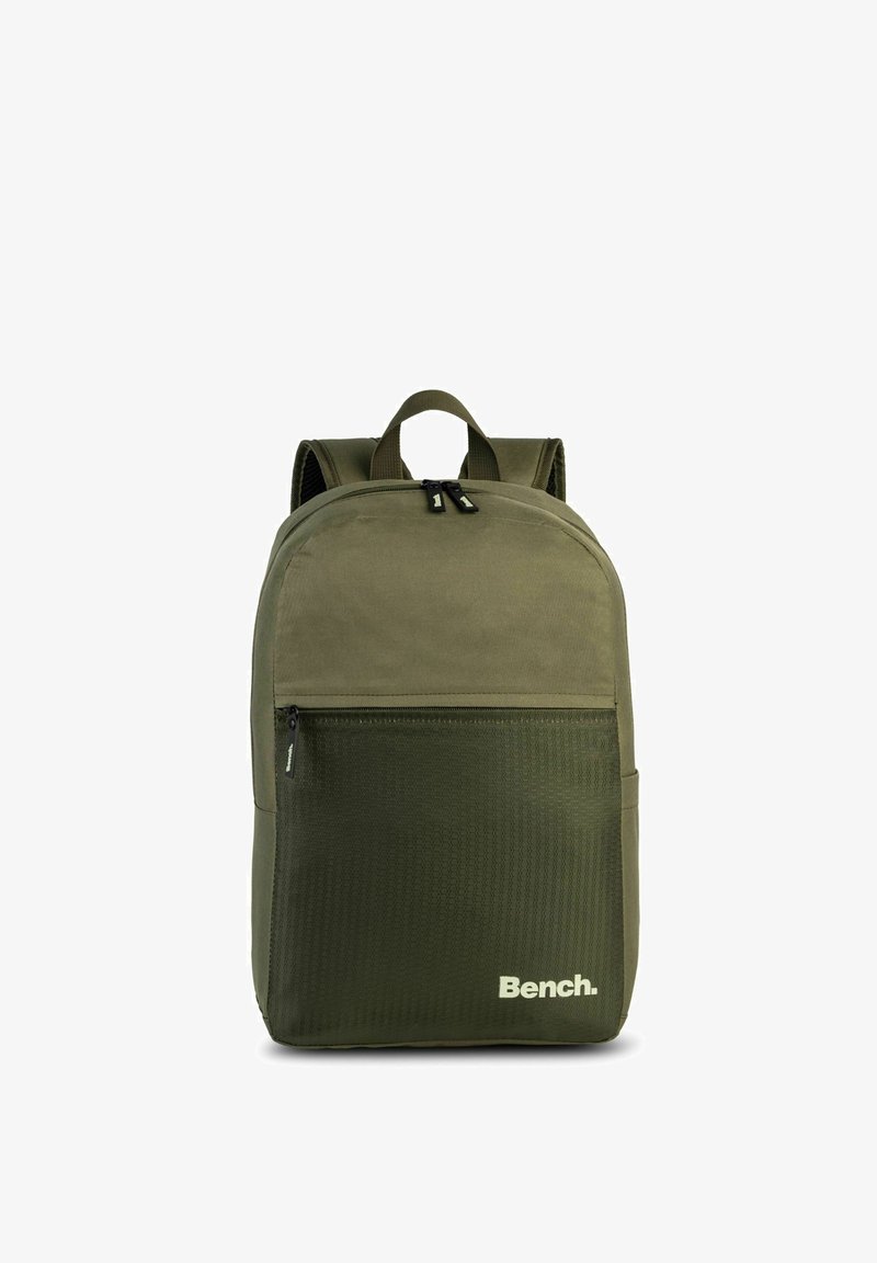 Green fabric backpack with a front zippered pocket, padded straps, and a top handle. Features a textured lower section and "Bench" logo.