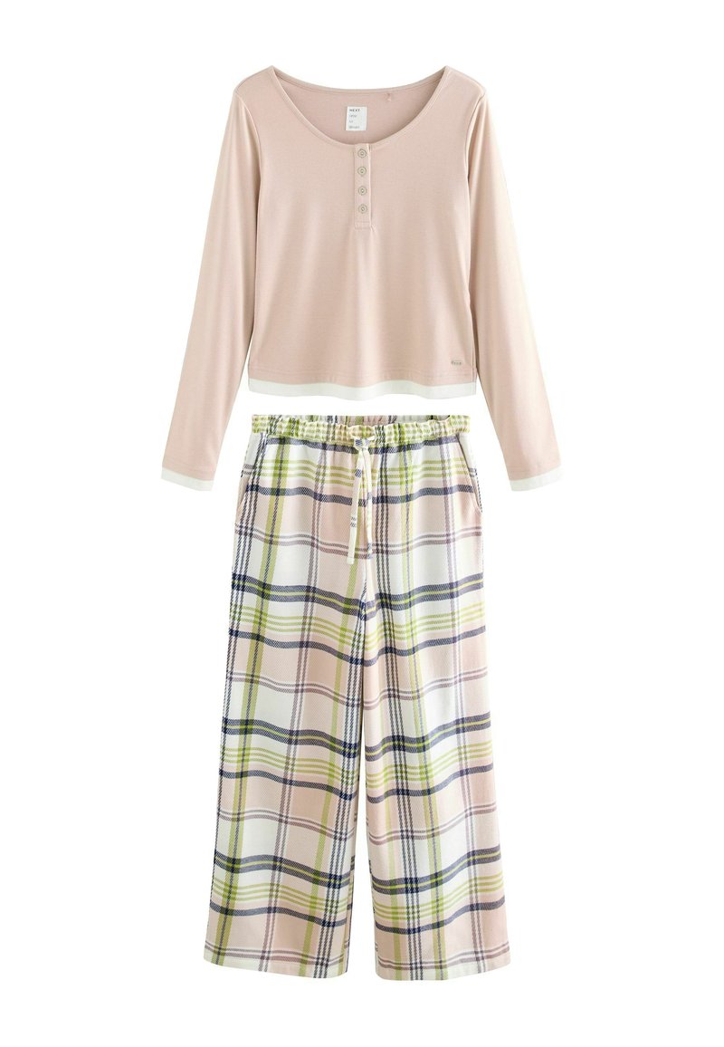 Light pink long-sleeve top with buttons paired with wide-leg plaid pants featuring green, navy, and pink stripes and an elastic waistband.