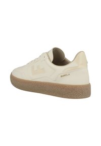 Light beige sneaker with a textured rubber sole, smooth leather upper, minimalistic design, and subtle branding detail on the side.