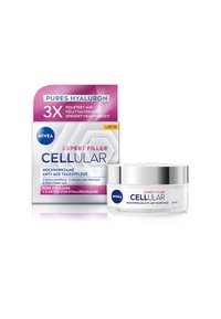 NIVEA Expert Filler Cellular cream in a white jar with silver cap. Box packaging features a pink top, blue logo, and hexagonal design elements.