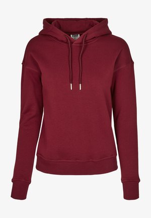 Burgundy kapucnis pulóver puha anyagból készült, húzózsinórral ellátott kapucnival, bordázott mandzsettákkal és laza szabásával, minimális varrásokkal.