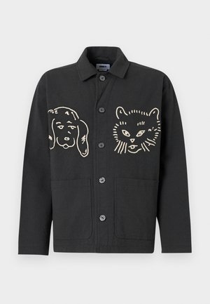 Black jacket featuring large, beige cartoon-style pet illustrations: a dog on the left and a cat on the right. It has button closures and pockets.