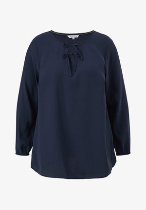 Blouse bleu marine à manches longues avec encolure ronde et deux nœuds noués à l'avant, poignets élastiqués et coupe ample.