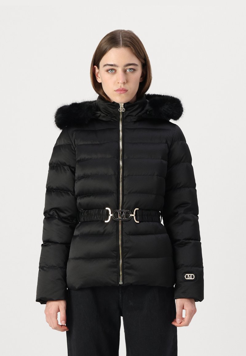 Black puffer jacket with a fur-trimmed hood, gold hardware, and a cinched waist featuring a logo detail. Textured quilted fabric.