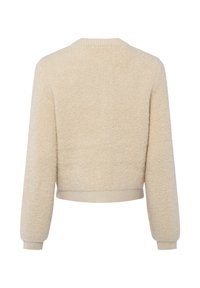 Beige cropped trui gemaakt van zacht, pluizig stof. Heeft een ronde halslijn en geribbelde boorden en zoom voor een aansluitende pasvorm.