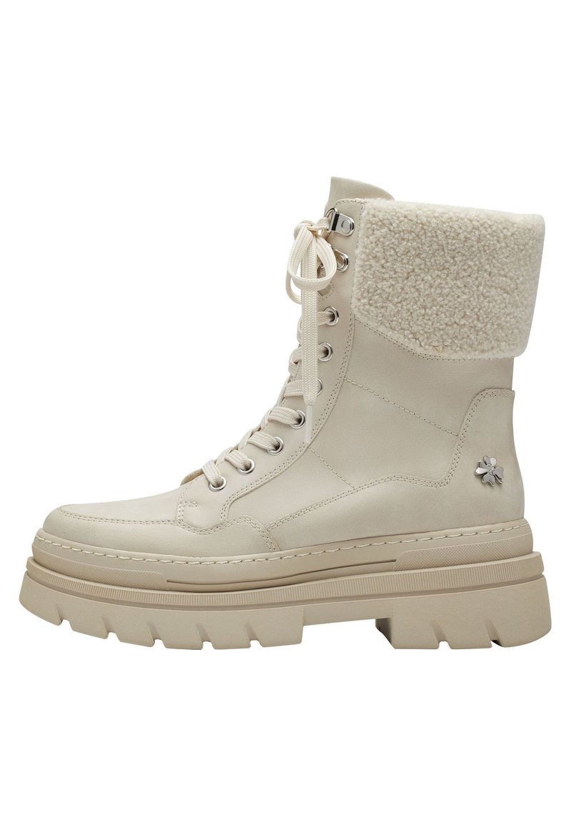Beige ankle boots with a plush shearling cuff, smooth leather upper, round toe, metal eyelets, and a thick, textured rubber sole.