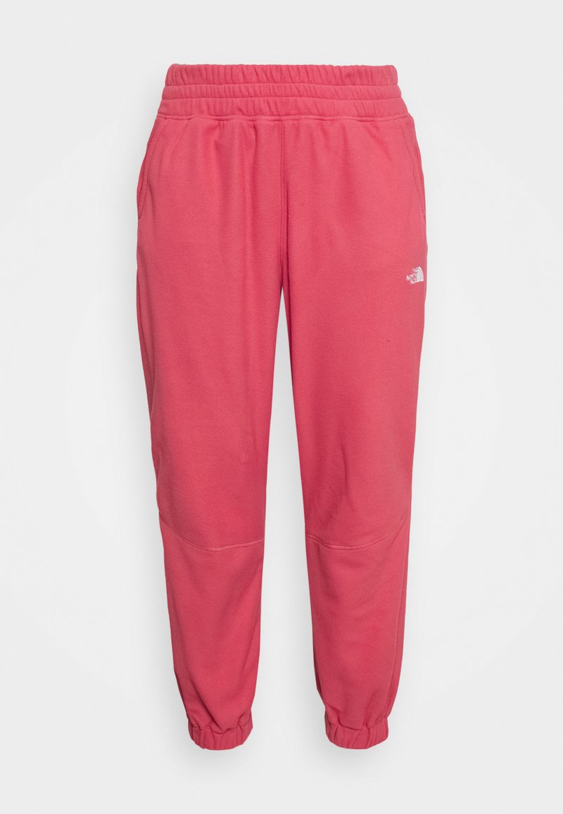 Calças de treino cor-de-rosa com cintura elástica e bainhas ajustadas. Apresenta bolsos laterais e um pequeno logotipo branco na perna esquerda. Tecido suave.