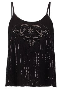 Camsole noire à fines bretelles ornée de perles délicates et de sequins dans un motif, créant une apparence texturée.