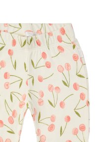 Leggings en coton avec une taille élastique, présentant un motif floral de cerises roses sur un fond crème et des feuilles vertes.