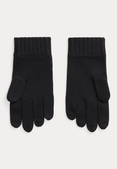 Paire de gants noirs en tricot avec poignets côtelés, posés à plat, montrant la face avant de chaque gant sur un fond clair uni.