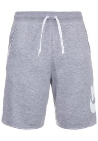 Šedé sportovní šortky z bavlny s vázací šňůrkou v pase, bočními kapsami a velkým bílým logem Nike na spodní levé noze.