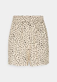 Béžové šortky s černými nepravidelnými skvrnami, s elastickým pasem a volným střihem, zobrazené na bílém pozadí.