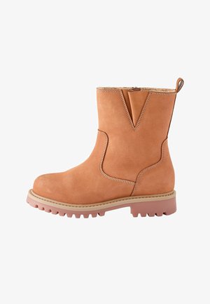 Bottine en suede beige avec un bout rond, une découpe en forme de V et une semelle en caoutchouc rose contrastante présentant un motif de semelle robuste.