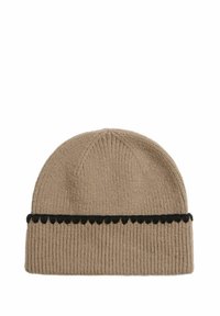 Beanie hat made from ribbed beige fabric, featuring a black scalloped accent band. Design is simple with a rounded top. Soft texture.