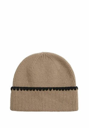 Beanie hat made from ribbed beige fabric, featuring a black scalloped accent band. Design is simple with a rounded top. Soft texture.