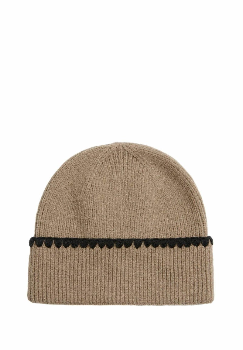 Beanie hat made from ribbed beige fabric, featuring a black scalloped accent band. Design is simple with a rounded top. Soft texture.