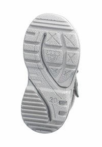 Suela de zapato de goma blanca con un diseño texturizado, surcos para tracción y un divertido patrón de cara de payaso en el centro.