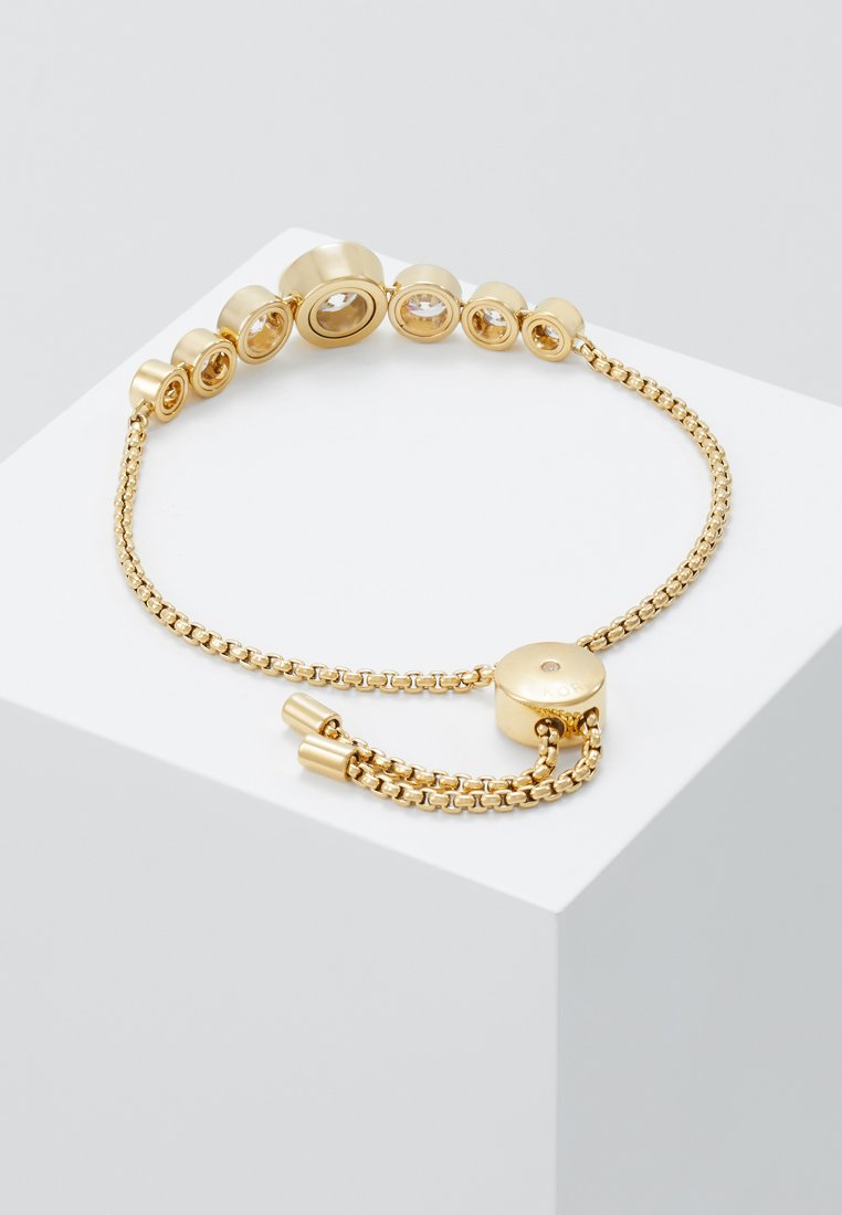 Goldene Armbanduhr mit einem Kettendesign und runden Akzenten in unterschiedlichen Größen sowie einem runden Verschluss mit strukturiertem Finish.