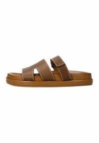 Brown synthetic slide sandal with two adjustable straps, cut-out details, white stitching, and a flat rubber sole.