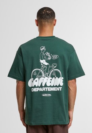 Green cotton t-shirt featuring a white graphic of a cyclist holding a coffee cup and text "CAFFEINE DEPARTEMENT" at the back.