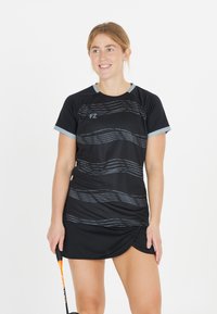 Musta urheilullinen mekko harmaalla aalto-kuviolla, lyhyet hihat ja vaaleansiniset yksityiskohdat kauluksen läheisyydessä. Kevyt kangas, joka on suunniteltu urheilua varten.