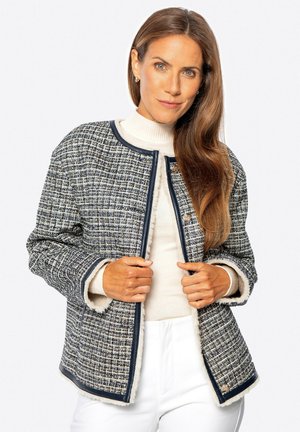 Strukturierte Tweed-Jacke in Navy und Weiß, mit rundem Ausschnitt, Knopfverschluss und weicher, kontrastierender Innenauskleidung.