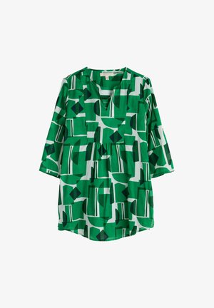 Grøn tunika med abstrakt geometrisk mønster i mørkegrøn og hvid. Har V-hals, 3/4 ærmer og en samlet talje. Letvægtsstof.