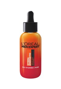 Le sérum L'Oréal Men Expert HYDRA ENERGETIC dans un flacon en verre dégradé orange avec un compte-gouttes noir et un étiquetage audacieux en noir et blanc.